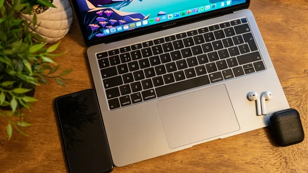 macbook pro on brown wooden table