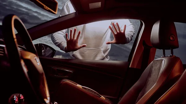 man in white long sleeve shirt driving car