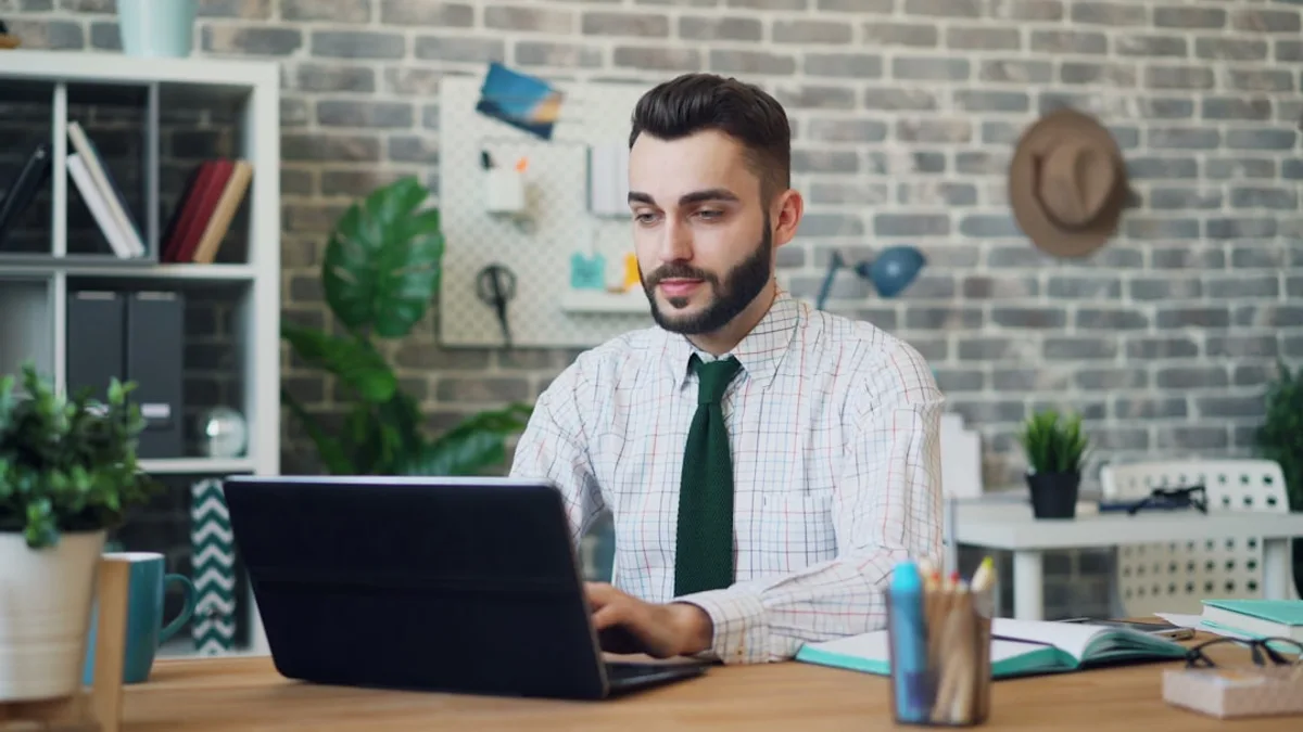person typing on gray and black HP laptop