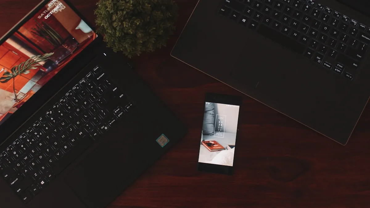 powered-on Android smartphone near two laptops