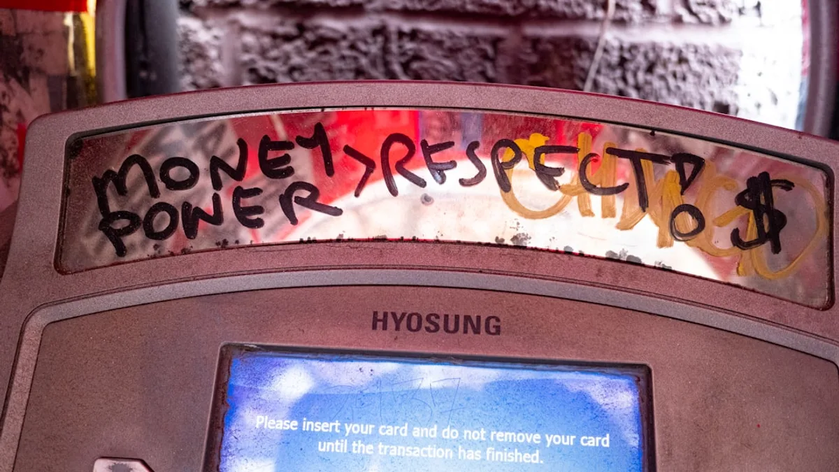 Graffiti on atm reads money, power, respect, and dollar sign.