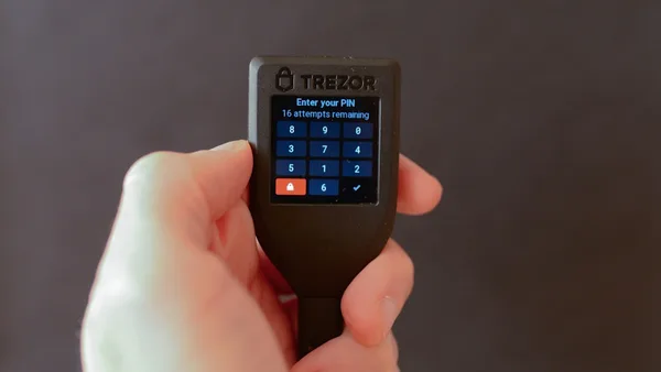 a person holding a cell phone in their hand