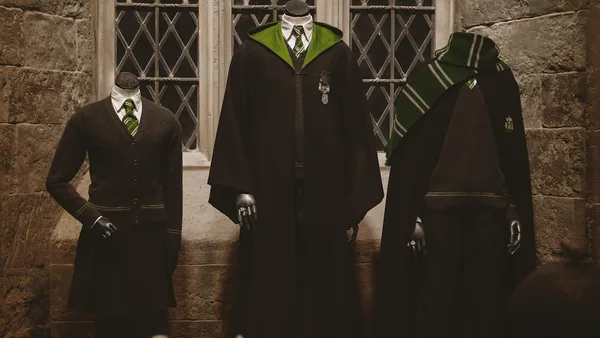 man in black academic dress standing beside man in black suit