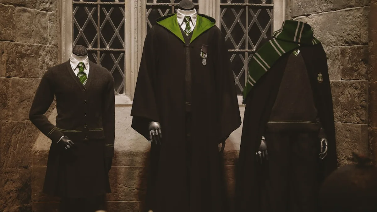 man in black academic dress standing beside man in black suit