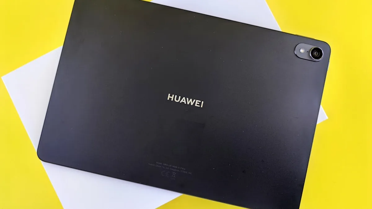 a black tablet sitting on top of a yellow table