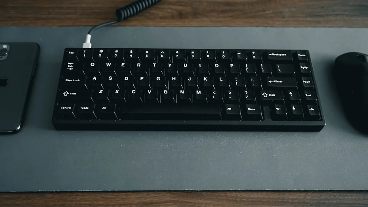 black computer keyboard on brown wooden table