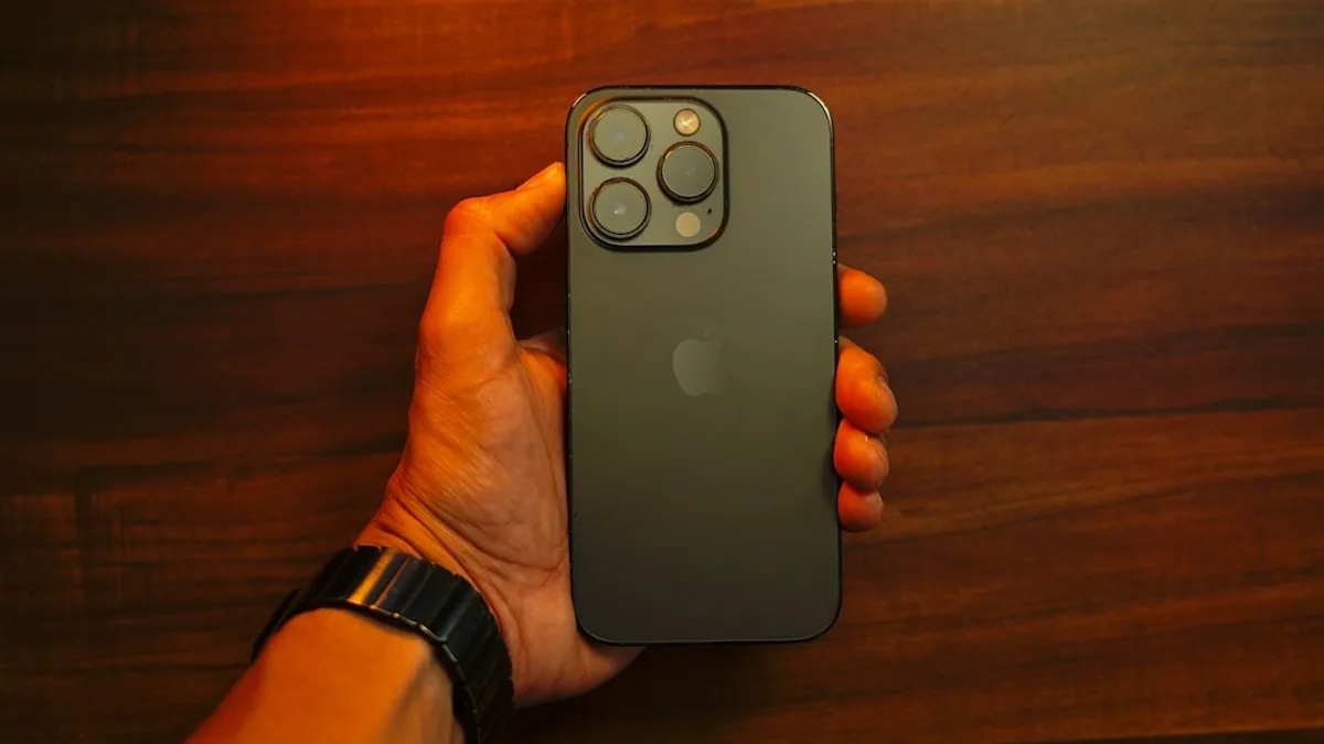 A person holding an iPhone in their hand