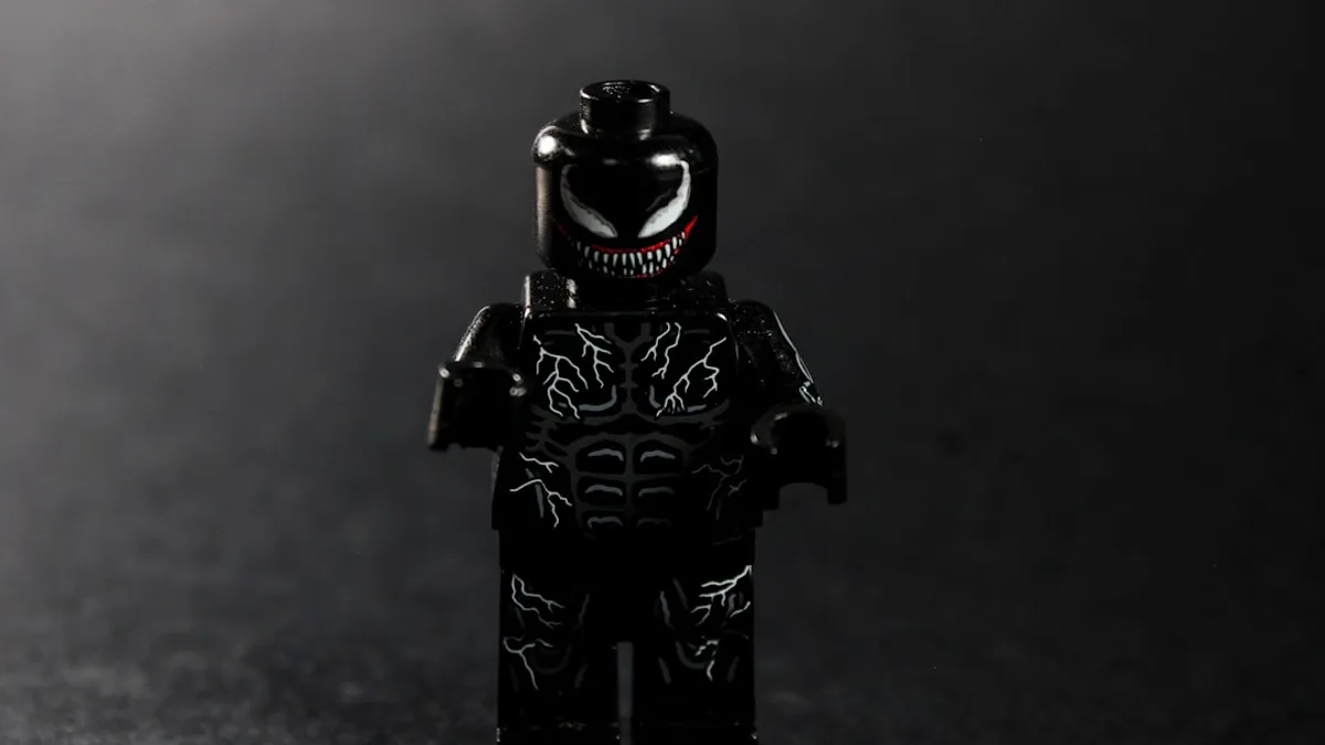 A black lego figure with white venom markings.