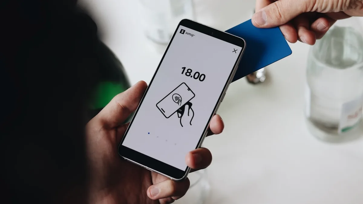 A person holding a cell phone in their hand