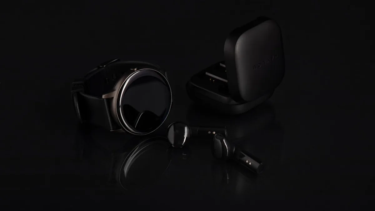 a pair of headphones and ear buds on a black surface
