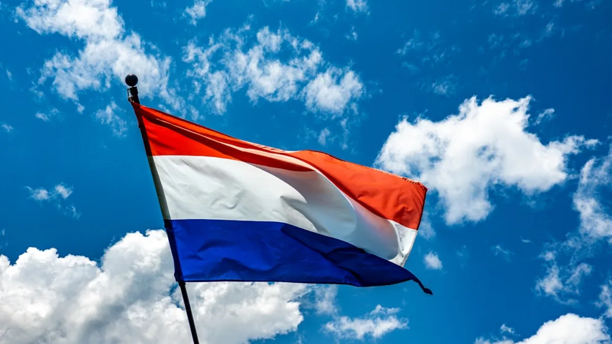 A red white and blue flag flying in the sky