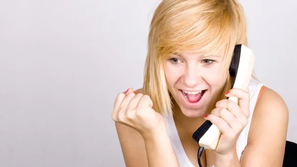 A woman holding a phone up to her ear