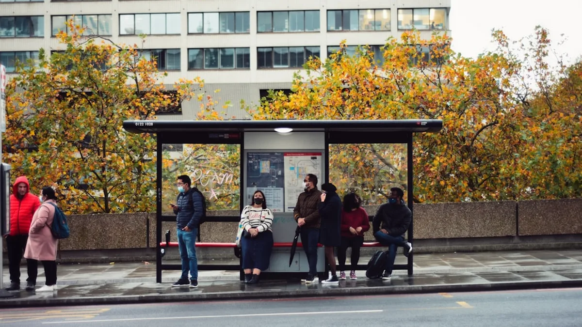 people sitting on bench in front of building during daytime