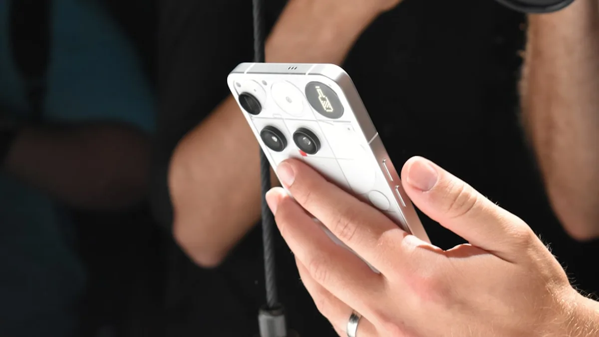 Person holding a white smartphone with a camera lens