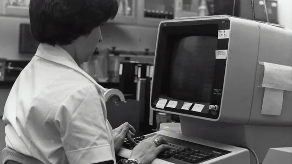 grayscale photography of unknown person using computer
