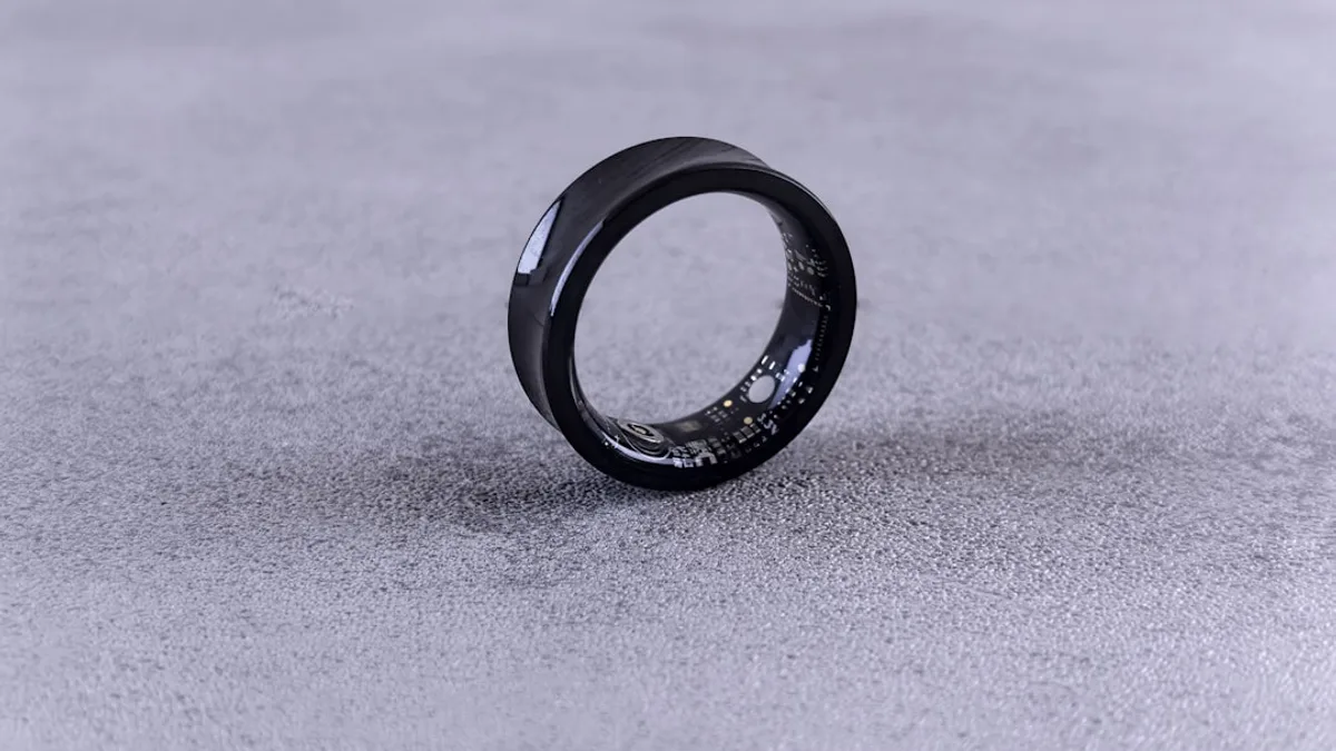 A black ring with white speckles on a gray surface