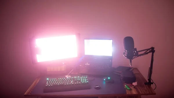 a desk with a computer and a microphone on it