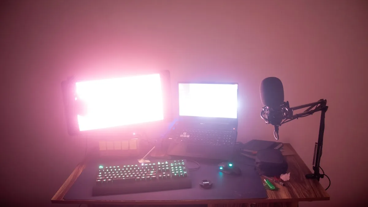 a desk with a computer and a microphone on it