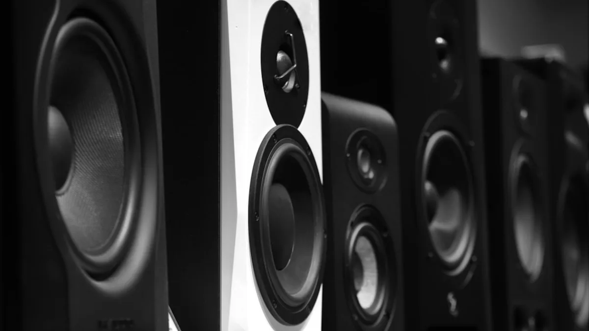 black and gray speakers on brown wooden table