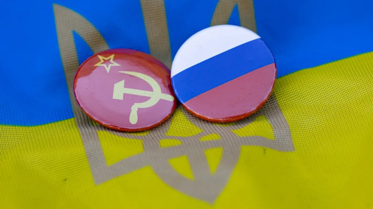 two buttons with the flag of the country of north korea and the hammer and sick
