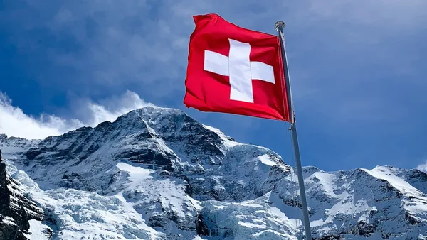 red flag on top of snow covered mountain