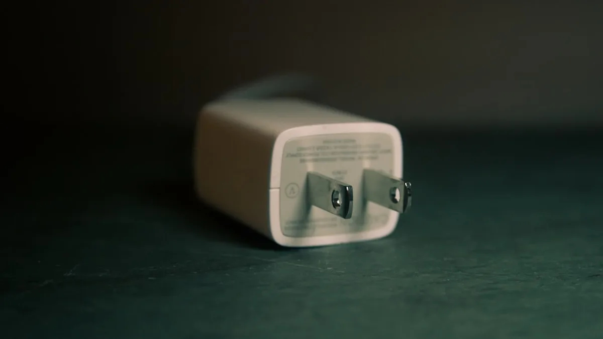 shallow focus photography of white travel adapter