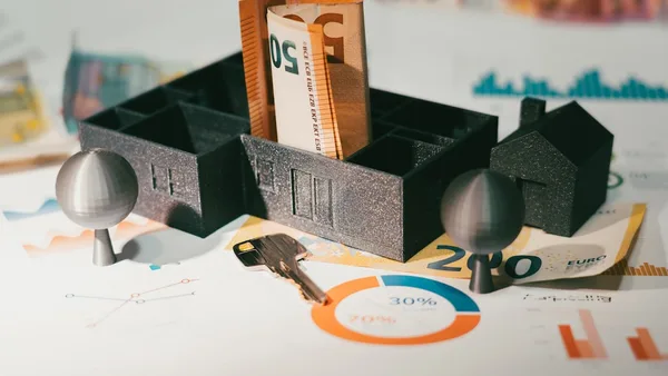 A couple of keys are sitting in a holder
