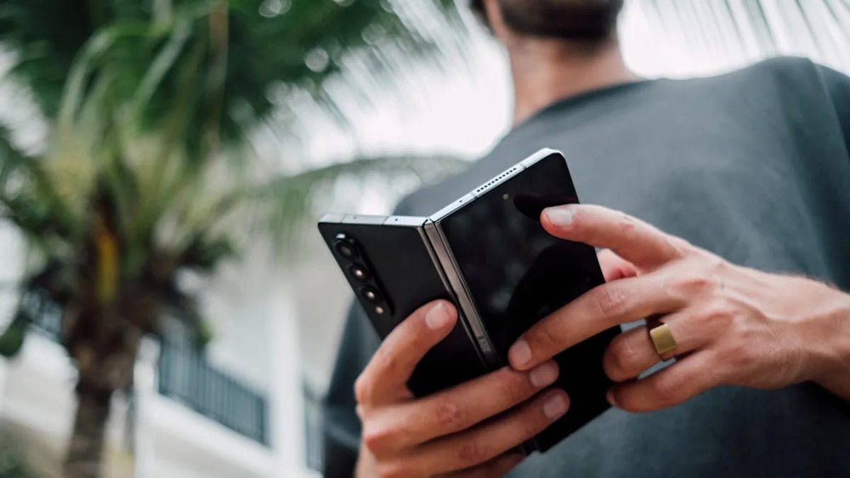 a man holding a smart phone in his hands