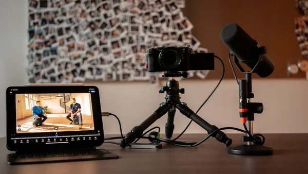 Camera, microphone, and monitor on a desk.