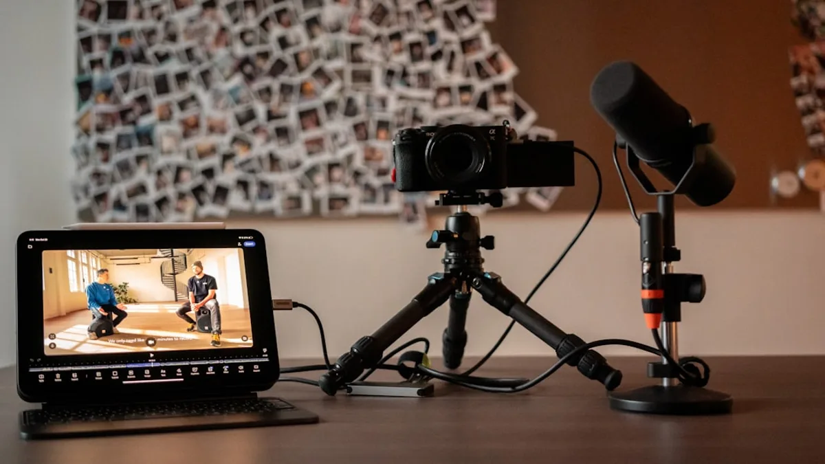 Camera, microphone, and monitor on a desk.