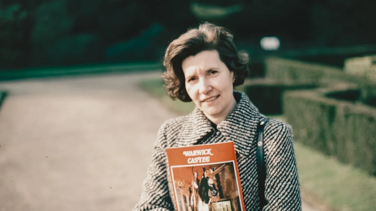 a woman is holding a book in her hands