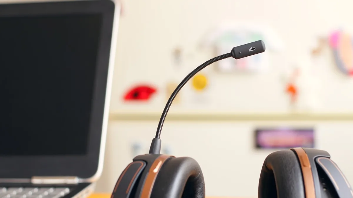 black and brown headset near laptop computer