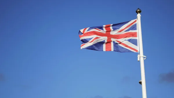 us a flag on pole under blue sky during daytime