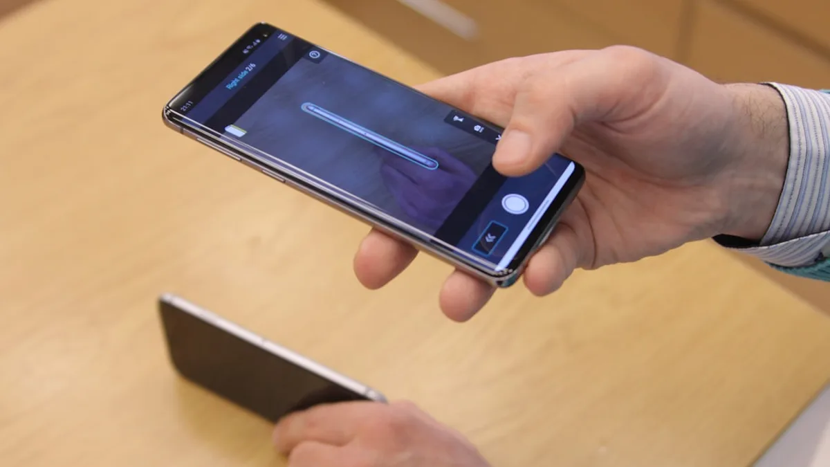 a person holding a cell phone in their hand