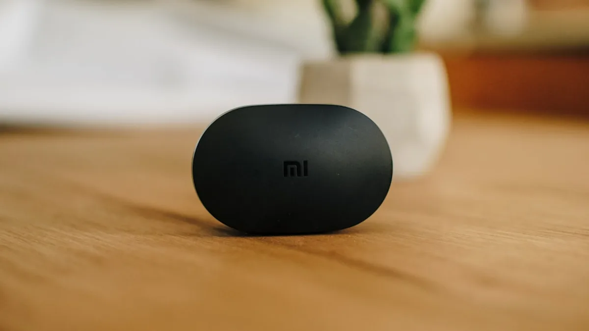 black round speaker on brown wooden table