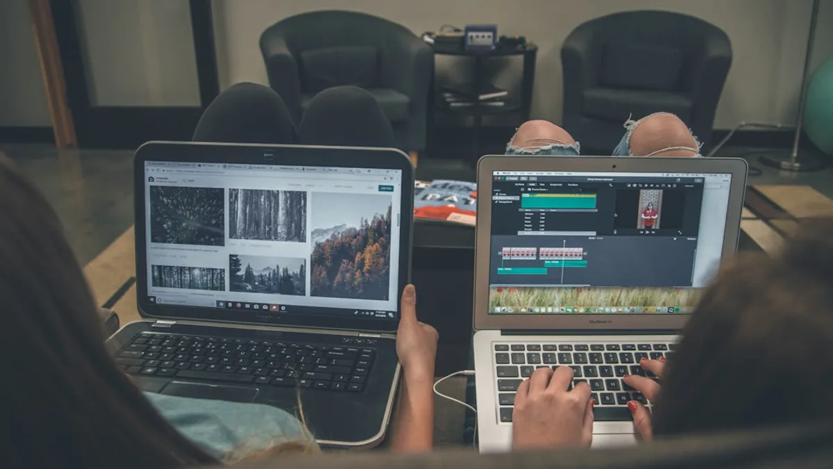 two person with laptop on lap sittig