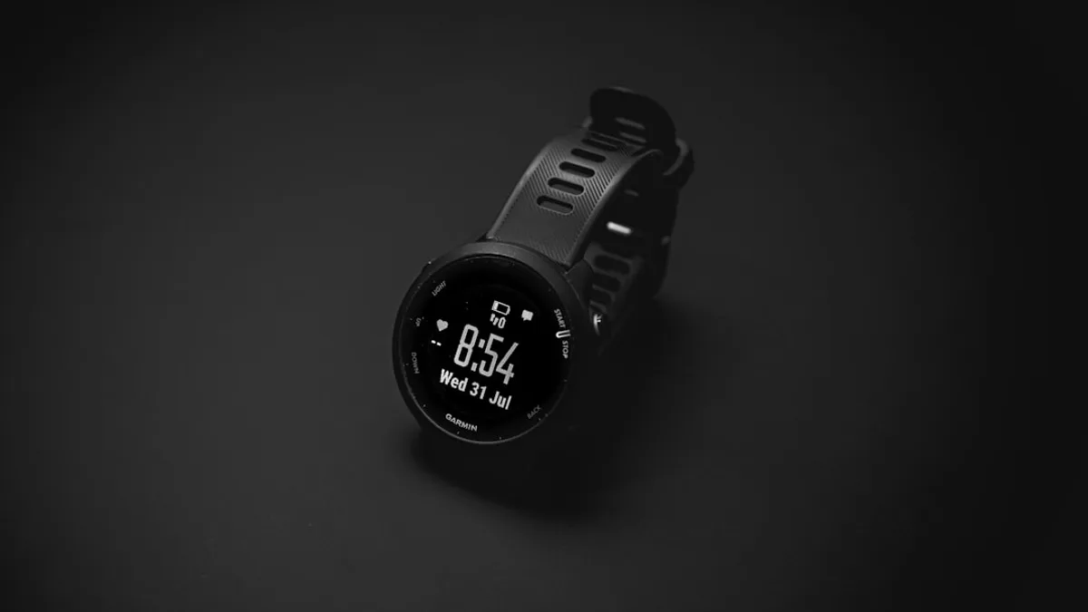 A smart watch sitting on top of a black surface
