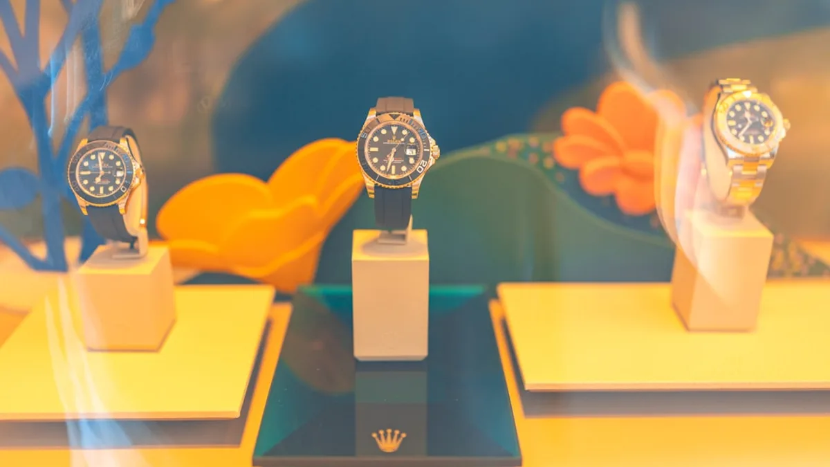 Three watches displayed on stands in a vibrant setting.