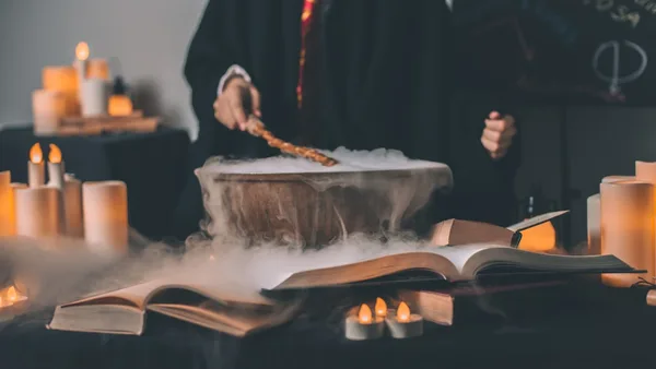 person holding wand on top of bowl