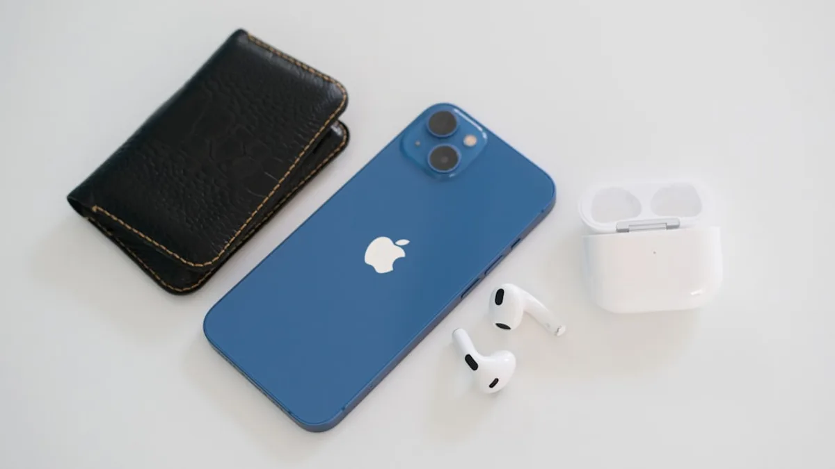 an iphone, earbuds, and wallet on a table