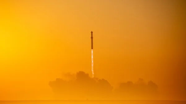 a rocket is flying through the air on a foggy day