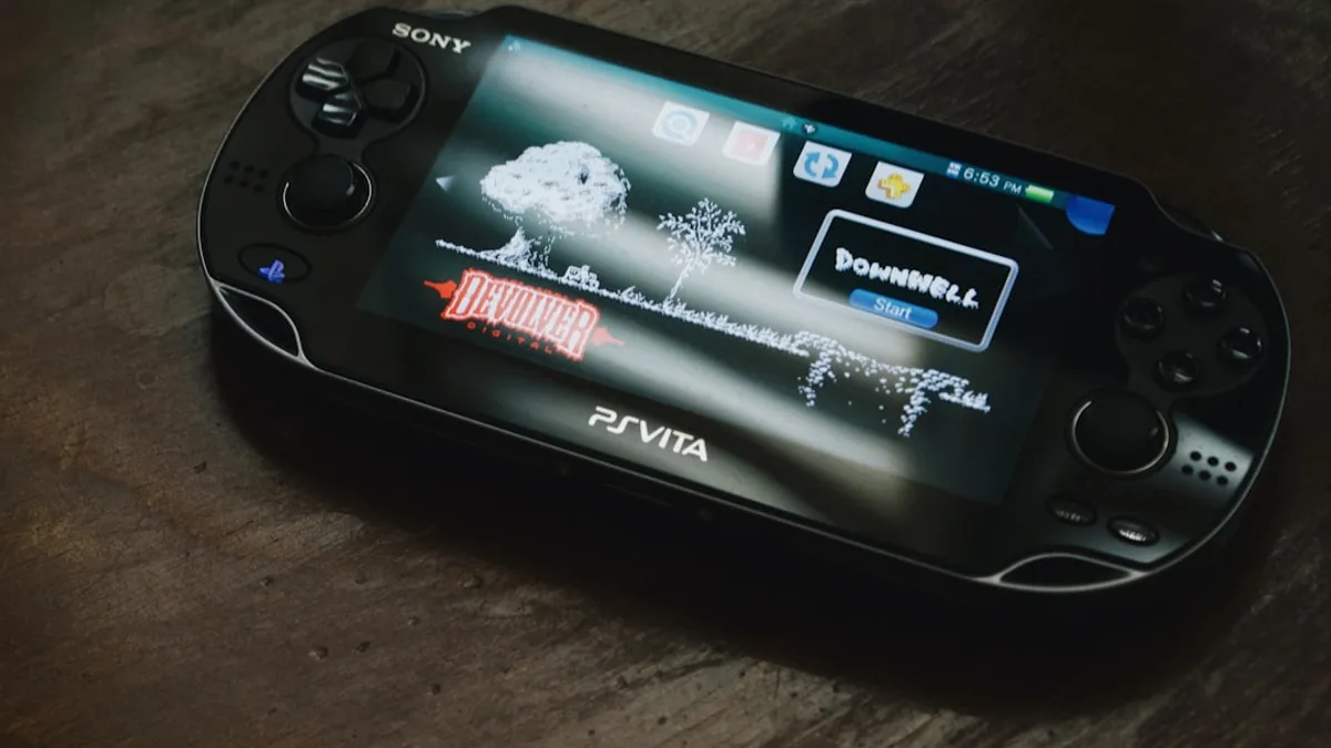black Sony PS Vita on brown wooden surface