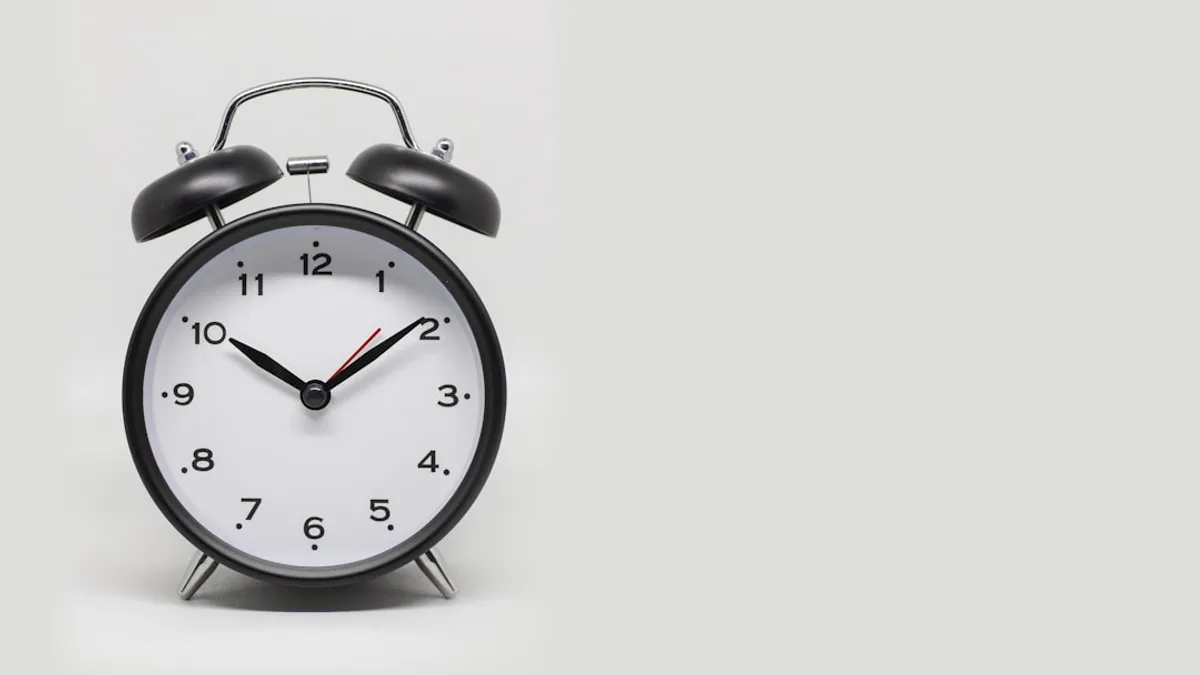 a black and white alarm clock on a white background
