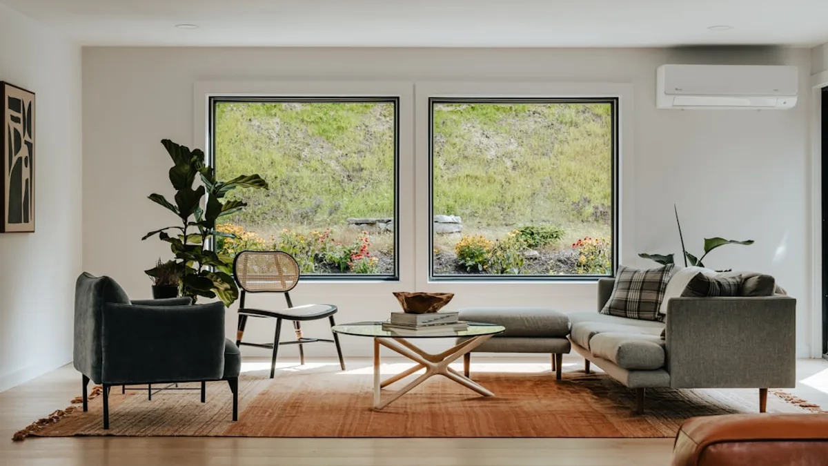 A living room filled with furniture and large windows
