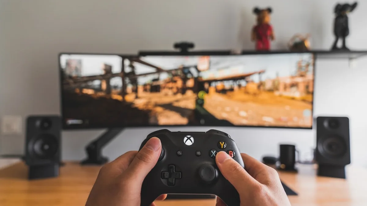 person holding black game controller