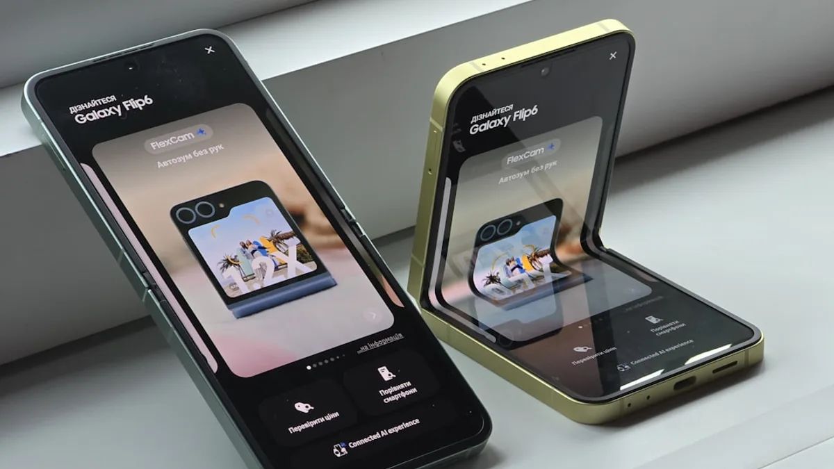 Two cell phones sitting next to each other on a window sill