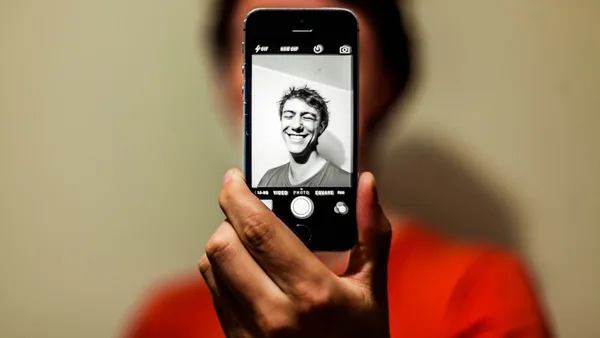 person holding space gray iPhone 5s taking picture