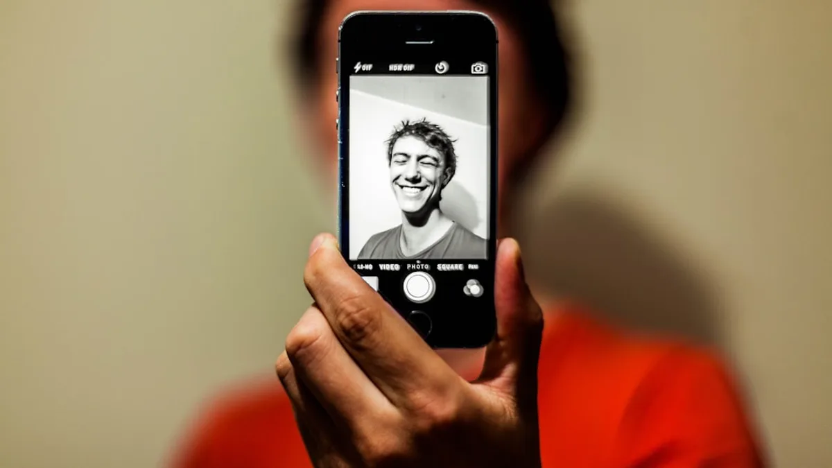 person holding space gray iPhone 5s taking picture