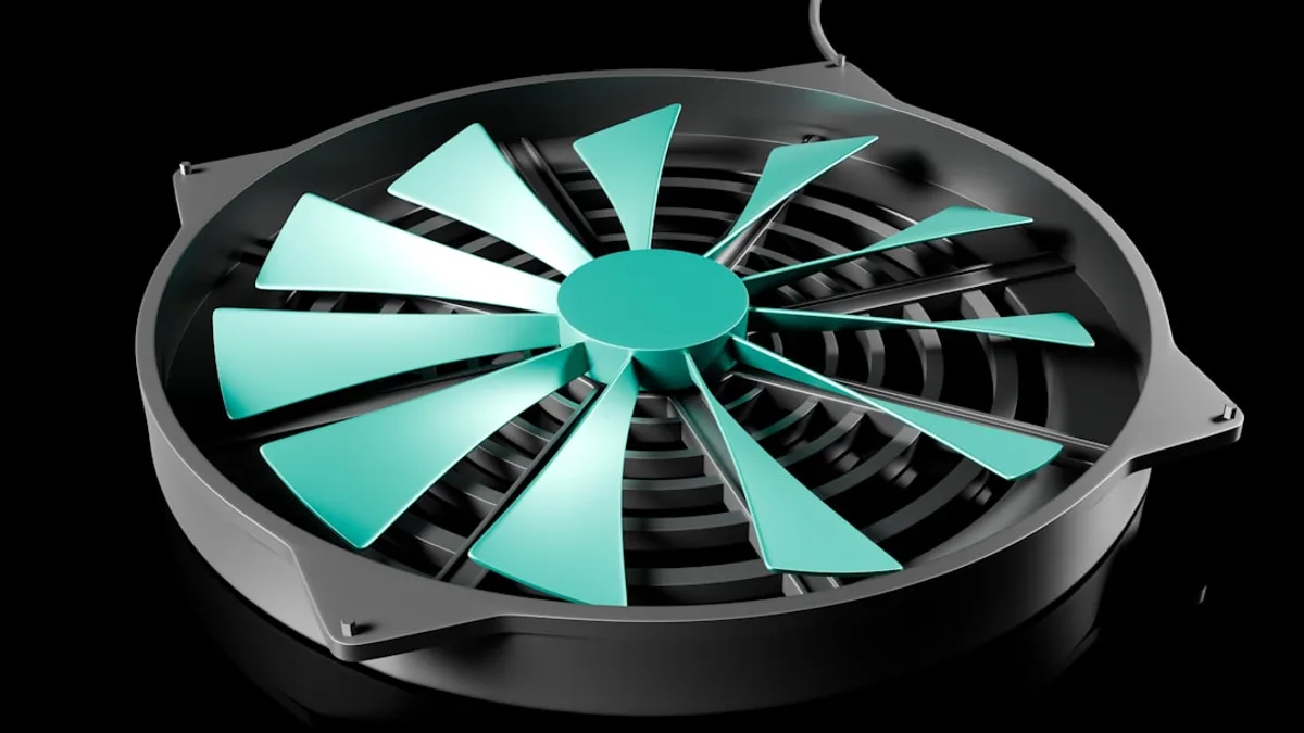 A black and green fan on a black background