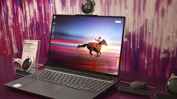 Laptop displaying a horse racing on its screen.